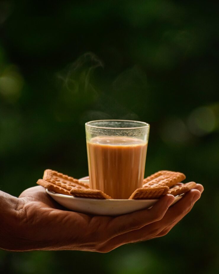 close up hand holding coffeetea cup biscuits 1048944 19766752
